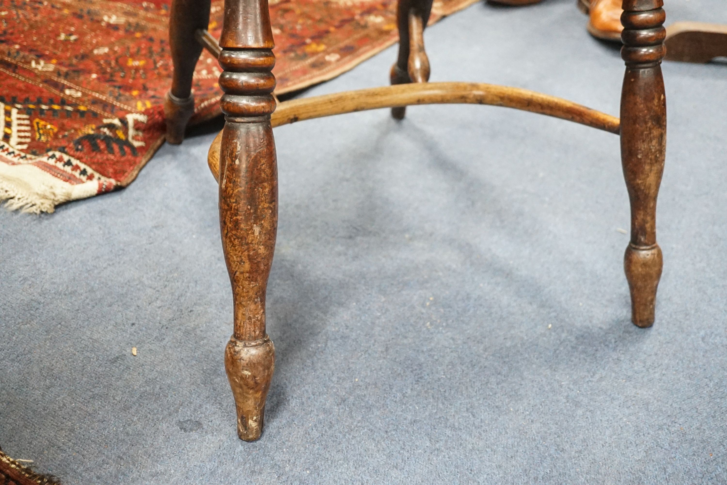 A 19th century yew and elm Windsor elbow chair with blind splat and crinoline stretcher, width 55cm, depth 40cm, height 93cm